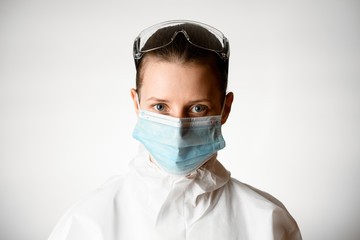 Fototapeta na wymiar Portrait of young woman in medical mask on white background.