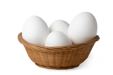 Eggs. White chicken eggs in a basket isolated on a white background.