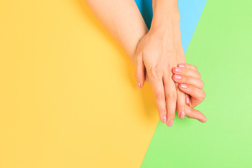 female  manicure. Beautiful young woman's hands on pastel color  background - Image