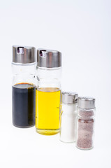 Set of glass bottles with olive oil, vinegar, salt and pepper for table setting