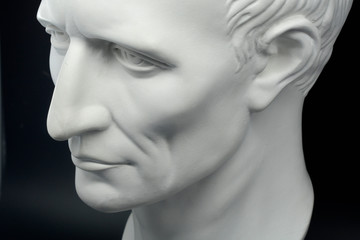  julius caesar roman emperor gypsum bust on black background