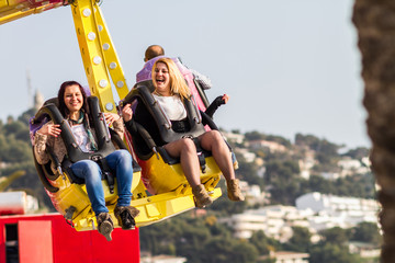 young people enjoying a day in the amusement park, attraction with happy face and smiling happy