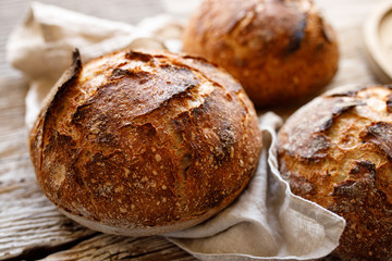 Homemade sourdough bread on a wooden rustic background, close up