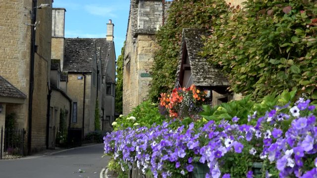 Pretty traditional English village Cotswolds cottages UK 4K