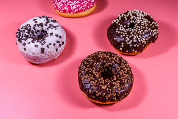 Fresh glazed donuts isolated on a pink background