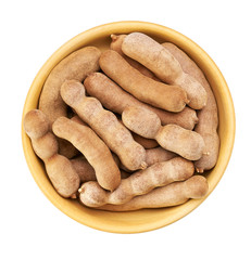 tamarind  in a wooden bowl isolated on white background, top view.