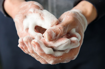 Hands with foam, close-up. Skin disinfection.