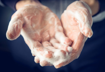 Man's hands washed with soap and foam, close up.