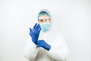 Fototapeta na wymiar portrait of tired doctor after shift in the hospital. The doctor in protective clothing - glasses, mask, gloves on white background. The doctor treating patients with coronavirus. Covid-2019