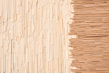 background of dried udon and soba, thin noodles made from wheat and buckwheat flour