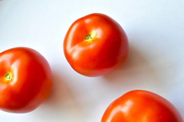 Red and juicy tomatoes on a white background