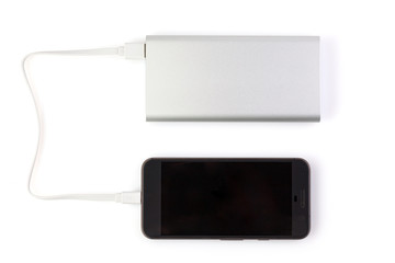 Power bank charges your smartphone  on white background. Universal external battery for gadgets....