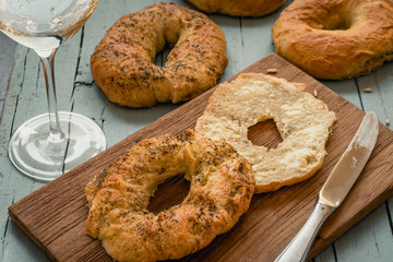 Homemade bagel with butter on a wooden board