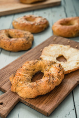 Homemade bagel with butter on a wooden board