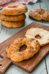 Homemade bagel with butter on a wooden board