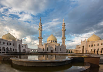 Beautiful white mosque in Bolgar reflected in the water against the backdrop of a beautiful sky
