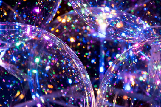 Crystal clear and transparent balloons with led colourful light inside sparkling and shining in the dark.