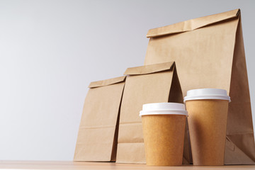 Paper bags with take away food and coffee cups containers. Lunch box