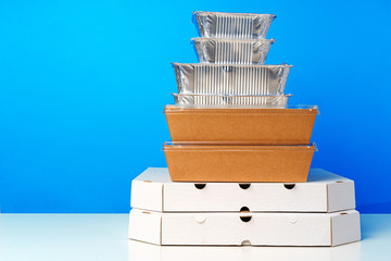 Assortment of various food delivery containers on table close up