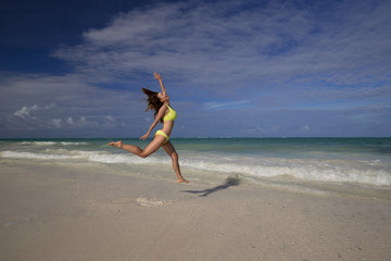 Fototapeta na wymiar Zanzibar, woman, yellow bikini, jump