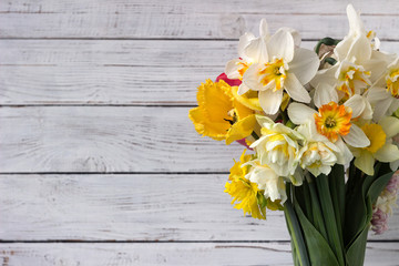 Bouquet of beautiful daffodils of different types and tulips, background. Spring flowers, terry and yellow stamens daffodils.