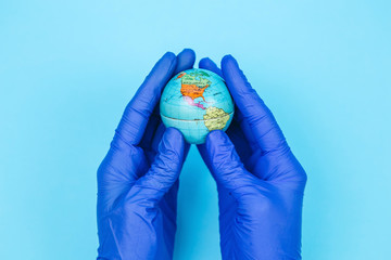 globe in the hands of the doctor. The inhabitants of the planet are fighting the coronavirus. The...