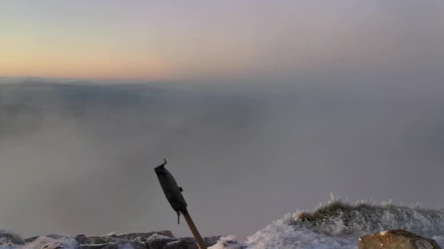 Mountaineer reaching Amboto summit with ice in winter