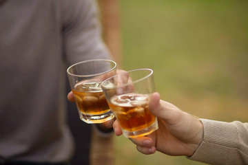 
whiskey with ice in glass glasses