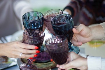 
wine in glass glasses that are held in hands