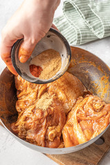 Raw piece of marinated chicken with spice and sauce prepered for barbecue