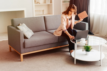 Young beautiful woman using a laptop computer at home