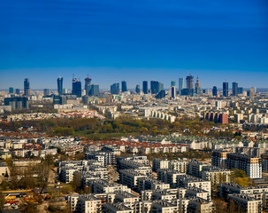 Beautiful panoramic aerial cityscape - view from the window of the plane landing at the center of Warsaw (Poland) with skyscrapers, with parks and residential areas, spring at sunset
