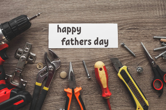a wooden table with a bunch of tools and the Happy fathers day sign.