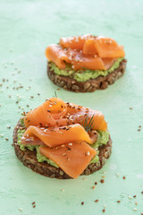 Whole grain bread toast with smoked salmon and mashed avocado
