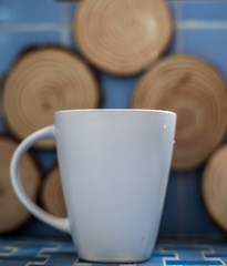 Steaming cup of coffee with tree ring background