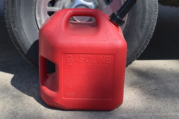 Gas Can by a Car Tire