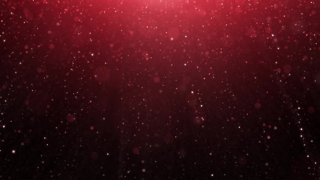 Artistic red coloured bokeh with flare and falling particles. Copy space background animation.