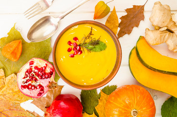 Spicy pumpkin carrot soup cream with pomegranate.