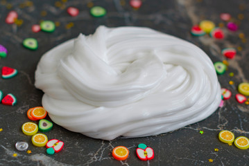 close up homemade toy white butter slime and accessories for decoration