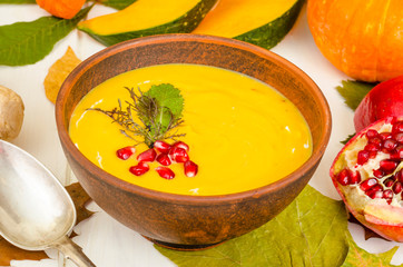 Spicy pumpkin carrot soup cream with pomegranate.