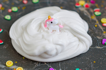 close up homemade toy white butter slime and accessories for decoration