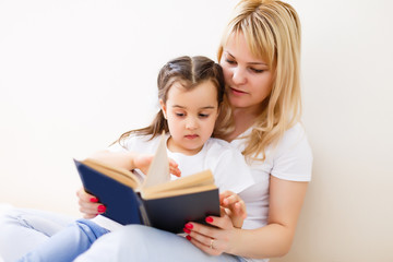 Fototapeta na wymiar Mother and daughter doing homework at home