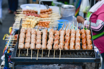 Sausages in small grill at food market