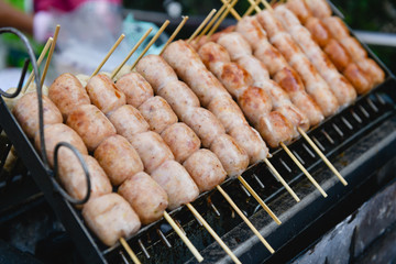 Sausages in small grill at food market