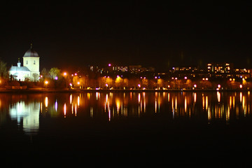 Night view on the city light reflected in the lake, Ternopil, Ukraine.