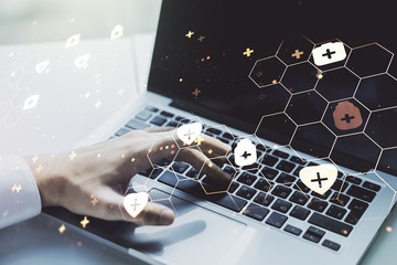 Double exposure of creative abstract medical hologram and hands typing on laptop on background. Healthcare technolody concept