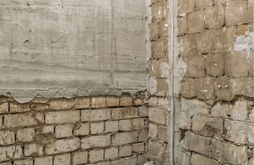 the process of aligning the walls during the repair in the apartment. old bricks and a new fresh layer of cement