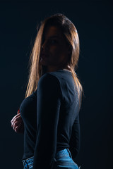 Silhouette picture of beautiful woman posing on black background