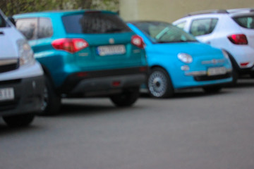 Fototapeta na wymiar Blurred cars of different brands in the parking lot