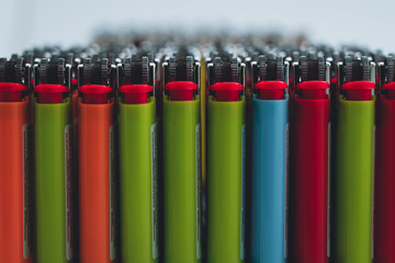 Many color lighters stand in line isolated on white background 